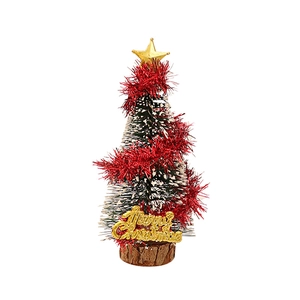 Miniature green Christmas tree with red tinsel and gold star on a wood base