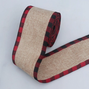Detail of burlap ribbon roll with rustic red and black buffalo plaid edges for DIY crafts