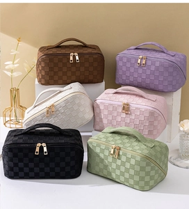 Six colors of checkered woven cosmetic bags with top handles and golden zippers