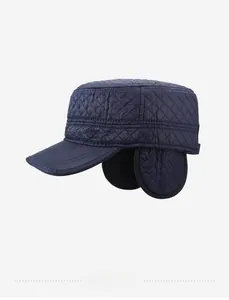 Detail of dark blue quilted flat top hat with foldable ear flaps for winter warmth