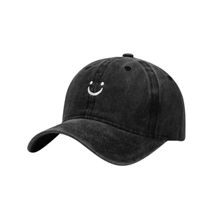 Vintage washed black baseball cap with white smile embroidery and a curved brim