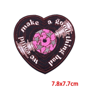 Detail of embroidered heart patch with star and quote measuring 7.8x7.7 cm