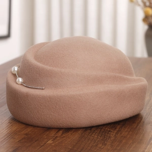 Détail de béret en laine avec perles et strass élégants sur table en bois