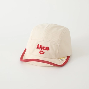 Cream five-panel baby baseball cap with red Nice embroidery and soft brim detail