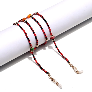 Handmade beaded eyewear chain with natural stones in red, black and gold tones