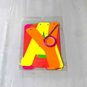 Neon letter banner kit with pink and orange letters, purple ribbon and plastic needle