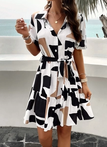 Short sleeve geometric print shirt dress with belt detail on an outdoor patio