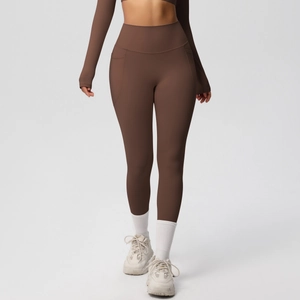 Close-up of high-waist yoga leggings in coffee brown with side pocket and stitching details