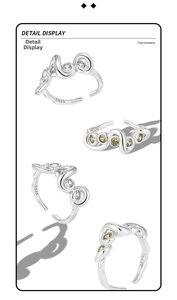 Detailed view of S925 silver wave rings with white and olive yellow gemstones
