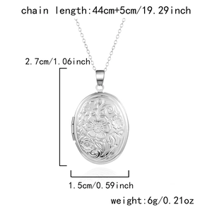 Silver oval locket pendant with floral relief and detailed size measurements