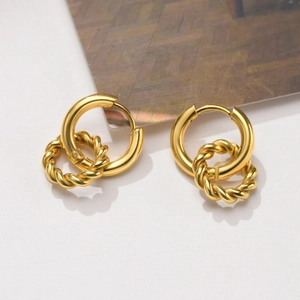 Detailed view of golden double-hoop earrings with smooth and twisted rope texture design