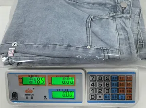 Weight measurement of light blue high waist flare jeans in size S on a digital scale