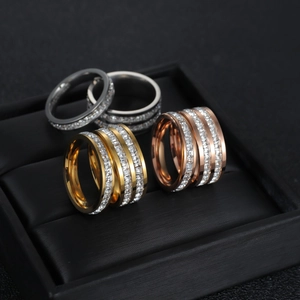 Close-up of three-layer rhinestone rings in gold, silver, and rose gold finishes
