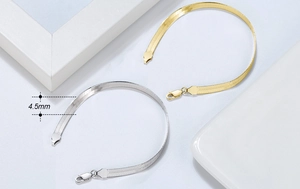 Detail view of 4.5mm wide herringbone snake chain bracelets in gold and silver finish