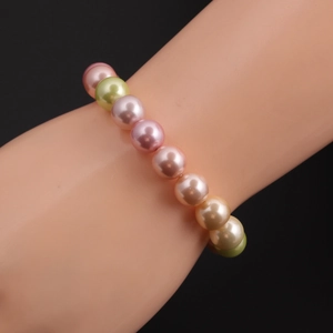 Detail view of colorful shell pearl bracelet with pink, green and champagne beads