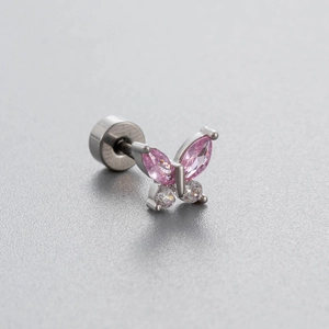 Silver butterfly ear stud with pink and white zirconia stones on a gray texture surface
