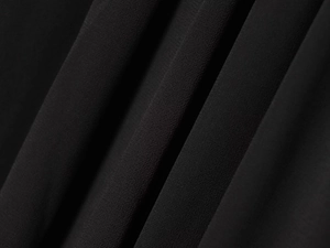 Close-up of black matte chiffon fabric showing soft drape and fine textured grain