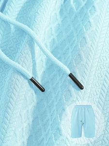Detailed macro view of light blue waffle texture shorts with drawstring and metal tips