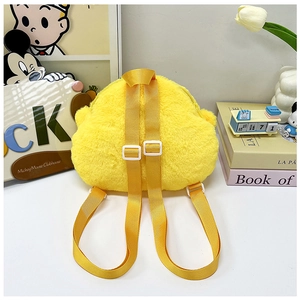 Detail view of the yellow plush backpack back featuring adjustable shoulder straps and top handle