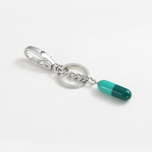Minimalist green capsule resin keychain with silver lobster clasp and key ring design