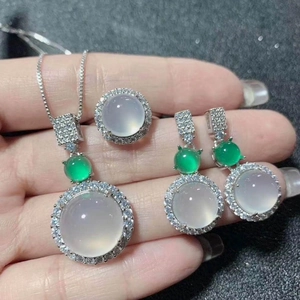Elegant jewelry set with white chalcedony necklace, ring and earrings on hand