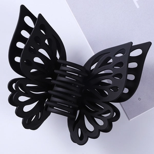 Detail view of large matte black hollow butterfly hair claw clip with 3D wings design