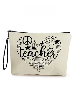Detail of canvas makeup bag with teacher heart graphics and black wristlet strap