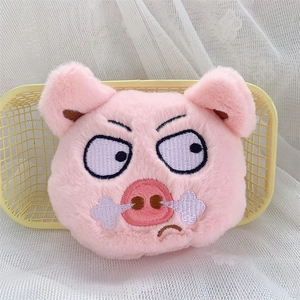 Close-up of pink plush pig coin purse with cute embroidered angry face expression