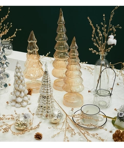 Close-up of glass Christmas tree figurines with amber and silver snowflake textures