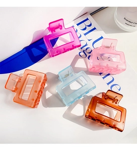 Close-up of five colorful hollow square hair claws in jelly finish on white background
