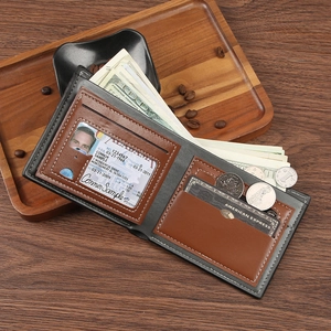 Men's bifold wallet in brown and grey leather on a wooden tray with coffee beans
