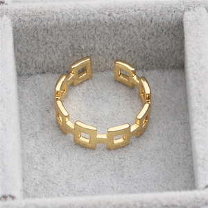 Modern gold hollow square linked open ring in a grey velvet jewelry box