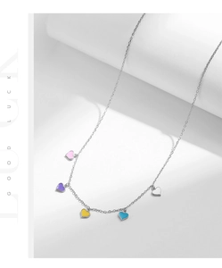 Detail of S925 silver chain with five colorful enamel heart pendants on white steps