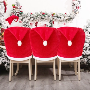 Festive red velvet Santa hat chair covers set for Christmas holiday dining room decoration