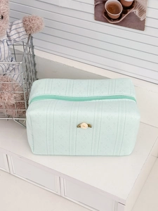 Quilted mint green cotton makeup bag with a small rose decoration and top zipper closure
