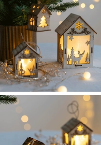 Close-up of glowing wooden Christmas house ornaments with warm LED lights on a festive tree
