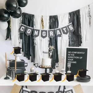 Graduation party decor set with black doctoral cap gift boxes and gold congrats banner