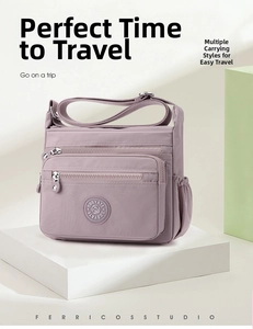 Detail of purple waterproof nylon crossbody bag with multiple zippers and adjustable strap