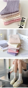 Detailed view of women's pastel argyle cotton socks with soft knit texture