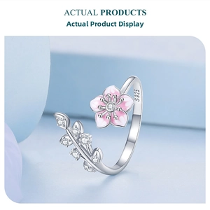 Macro shot of S925 silver cherry blossom ring with pink enamel petals and zircons