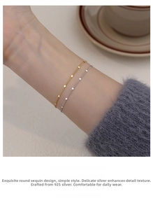 Detailed close-up of S925 sterling silver minimalist bracelet with round sequins on wrist