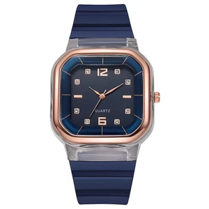 Detailed macro view of the dark blue square watch face with rose gold markers