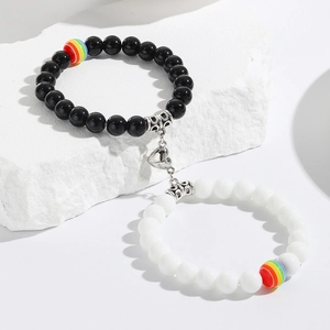 Detail of heart magnet clasp connecting black and white seed bead couple bracelets