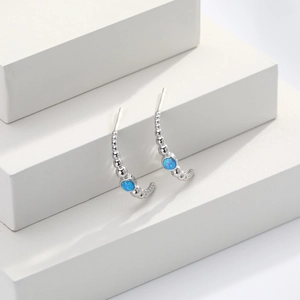 S925 sterling silver geometric arc stud earrings with blue opal stones on a white pedestal