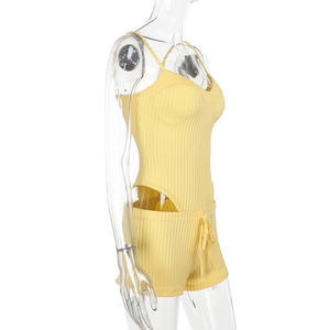 Detailed side view of yellow ribbed knit tank top and drawstring shorts on a mannequin