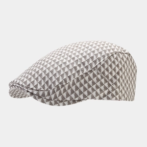 Close-up of British retro ivy cap with brown and white geometric triangle patterns