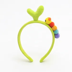 Detail of plush green tulip headband with a colorful caterpillar and soft 3D sprout