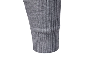 Close-up of gray knit sweater cuff showing detailed ribbed texture and quality stitching