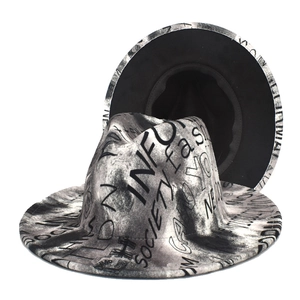 Detailed view of two street style fedoras with black and white graffiti text print