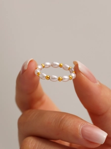 Macro view of beaded ring featuring white oval pearls and 18K gold plated steel beads
